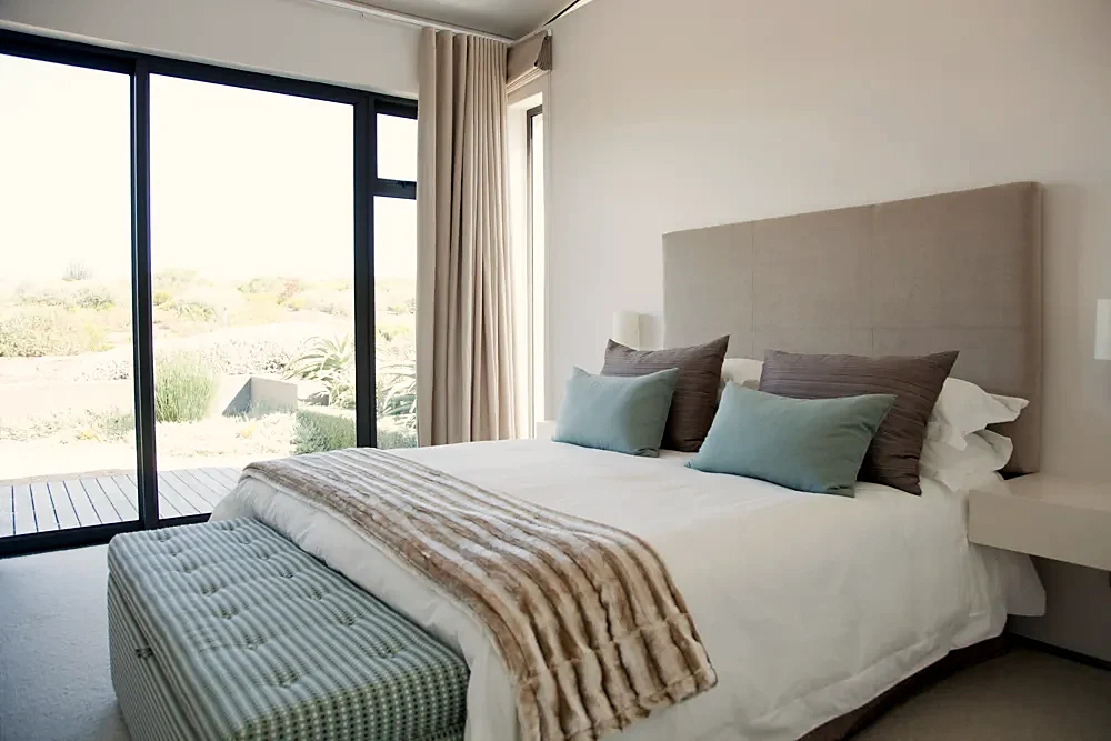 A bedroom with a bed and bench
