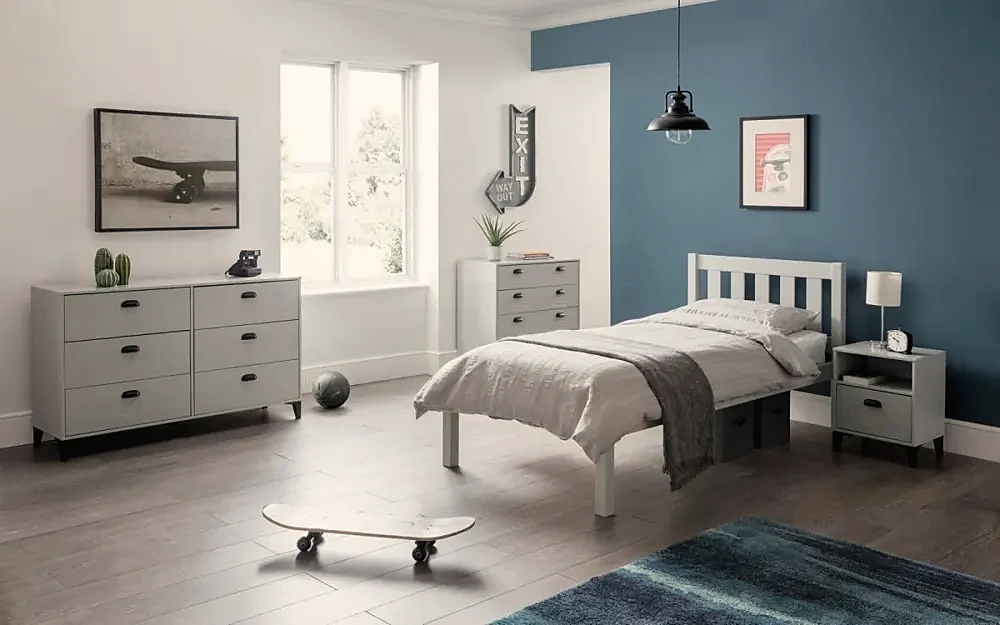 A child’s bedroom with a white bed