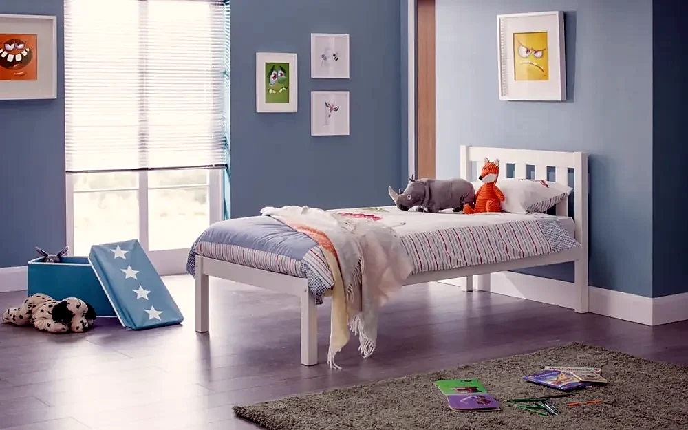 A child’s bedroom with a white bed
