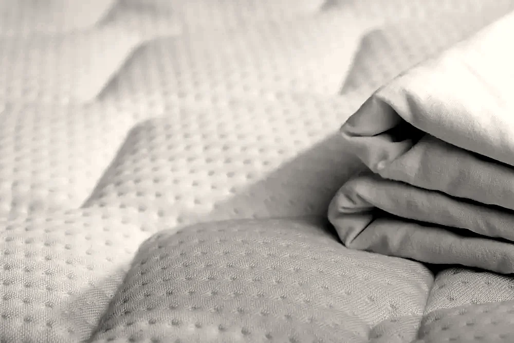 A close view of a mattress with sheets